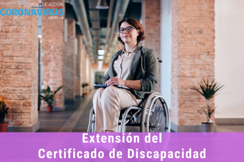 Foto de una mujer en silla de ruedas sonriendo, en el pasillo de un edificio